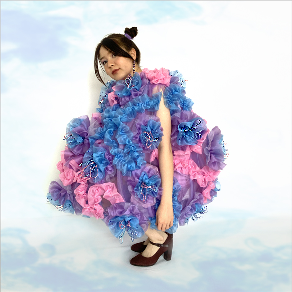 It took over 20 yards of different types of fabrics, such as organza, tulle and satin, in multiple colorways all being hand gathered and sewn together to create this look.