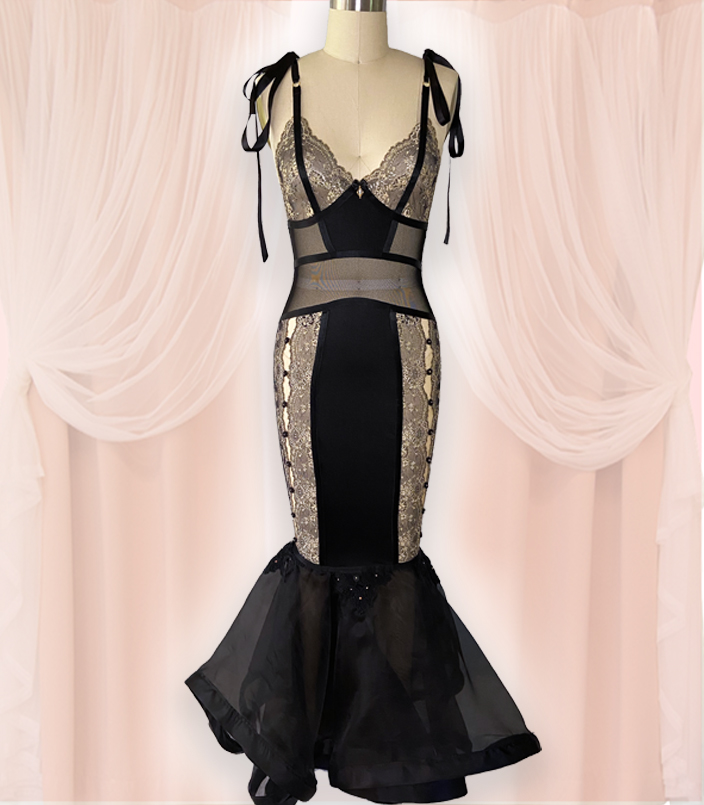 Inspired by the Madonna Inn located in California, vintage valentines, and the Victorian revival of the 1970s, this full-length control slip features two-toned lace, nylon spandex, power mesh, and silk organza. Details include silk ribbons, rosettes, Swarovski crystals, and lace appliqués where the skirt and slip meet.
