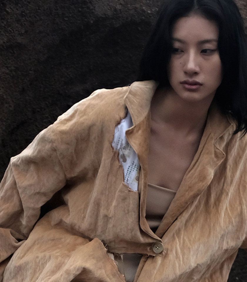 The deconstructed jacket was made of natural-dyed velveteen with burned raw edge detail. The velveteen was dyed with Pu’er tea and Chinese herbs. Eight-broken print on lining is exposed from the burned-out area on right shoulder. A lot of tailoring techniques were applied to both sides of the fabric. All edges were tacked and attached with cross and invisible stitches.