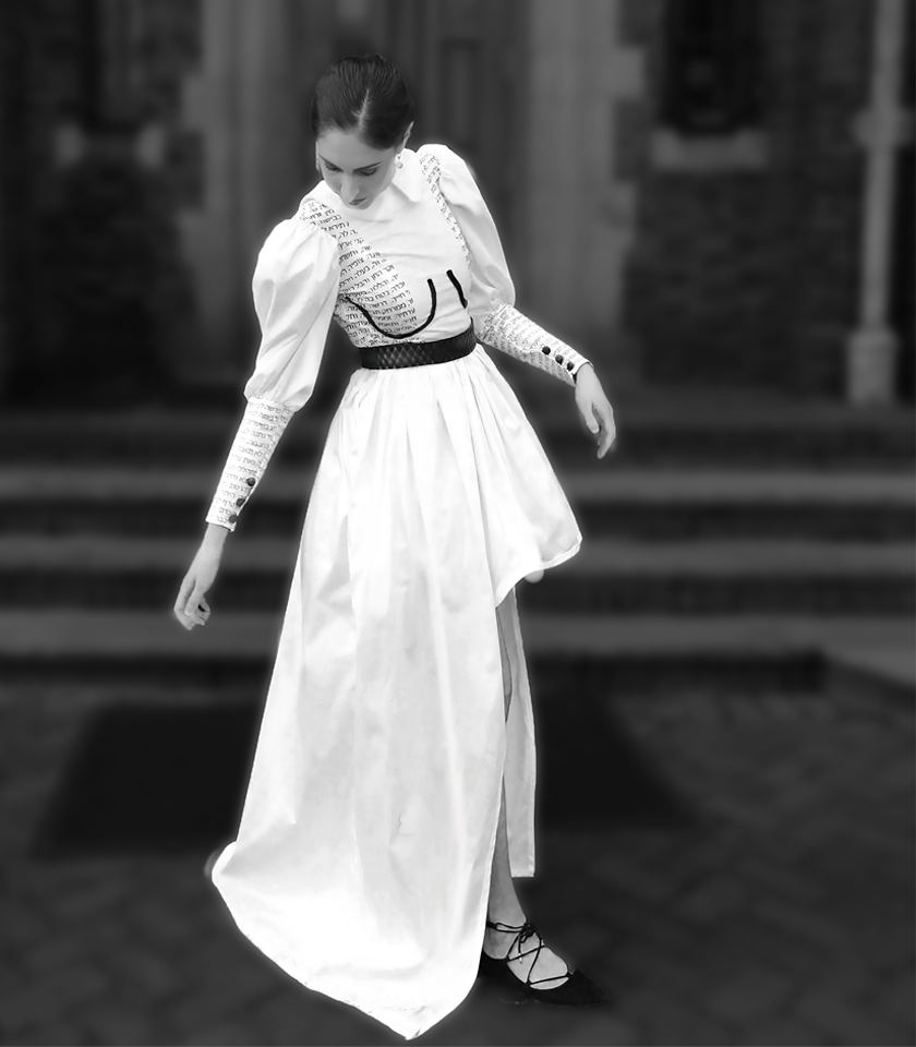 Front view of white garment with black Hebrew letters written over the cheat and sleeve areas
