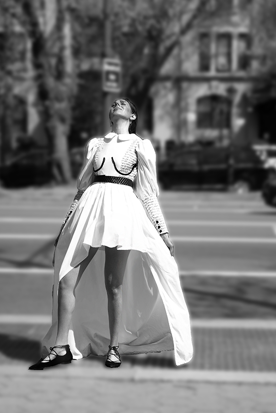 Front view, photo 2, of white garment with black Hebrew letters written over the cheat and sleeve areas