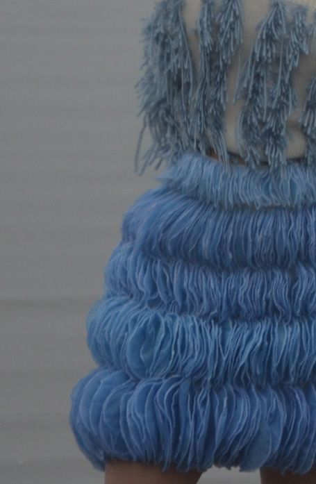 This dreamy look was inspired by the colors of the sky. The 600 hand-applied organza circles, in a myriad of sky-blue shades, represent clouds during different phases of the day.