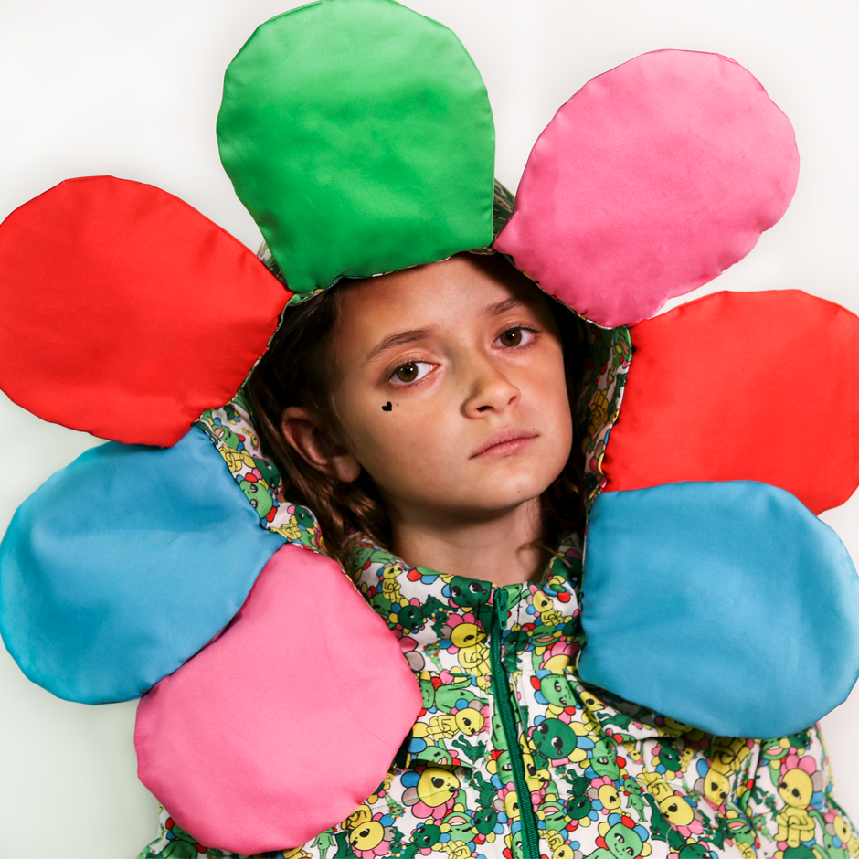 Close up view of the model wearing the puffer jacket with the detachable flower petal hood.