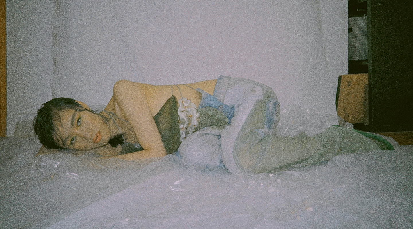 Photo 6 - Model on the ground, side view of garment