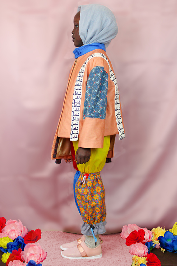 The Arabic word for “Inclusive” is embroidered on the white straps of the jacket.