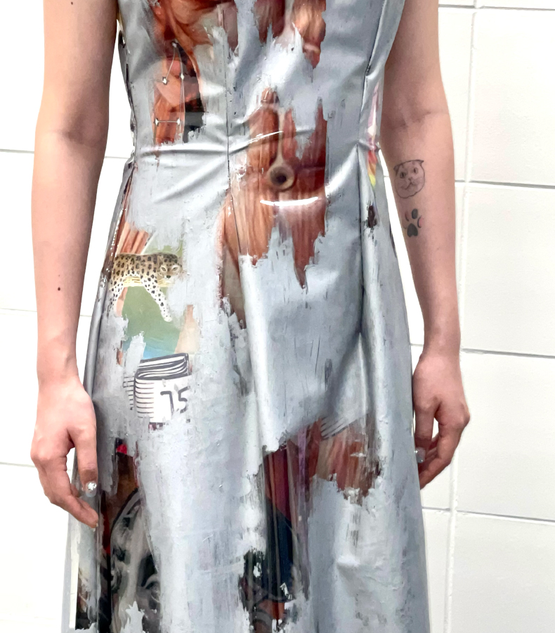 Close-up details. Human abdominal muscles and a face print. Some of the prints are covered with silver ink.