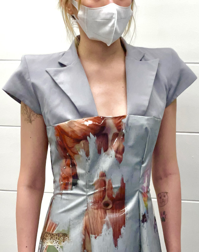 Close view of silver blazer joints dress, seam is above the chest.