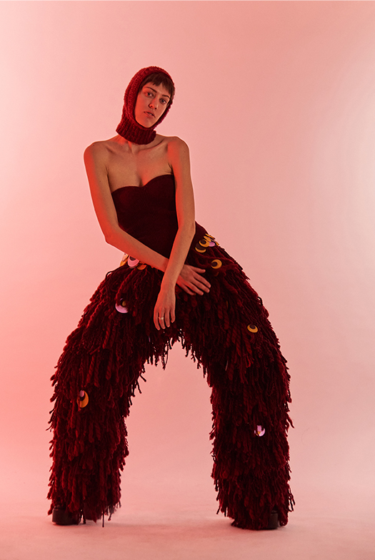 Burgundy stretch corseted bodysuit with lace pants, hand-appliquéd with fringe embellishment, using rug-weaving techniques