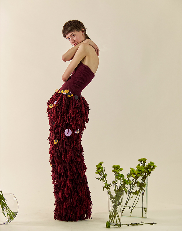 Side view of the garment with extra-fitted corset and super bulky pants