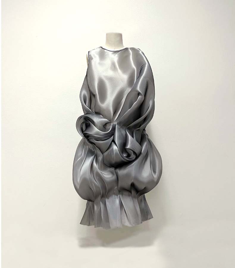 The asymmetrical, gathered shapes in this twill organza dress embody abstraction.
