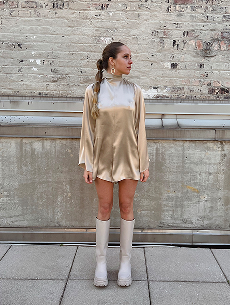 Front view of silk charmeuse romper that is very flowy. It has long sleeves and a turtleneck.