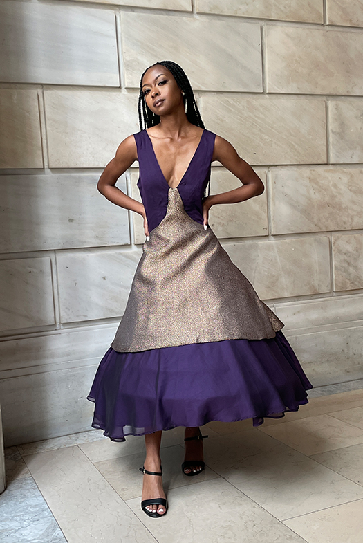 A front view detail shot displaying the entire dress without the jacket. Meant for versatility, the dress involves a deep V-neckline with thick shoulder straps for support and an A-line silhouette. The layered circle skirts are cut on bias to provide a soft and flowing ripple drape throughout the top and bottom skirts. The dress also keeps its shape within the skirt with the help of a hoopskirt that was cut to length.