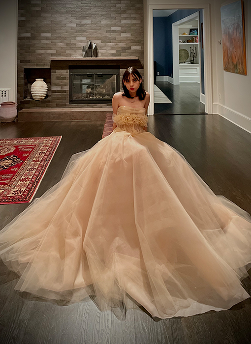 Gown embellished with handmade flowers that vary organically in size