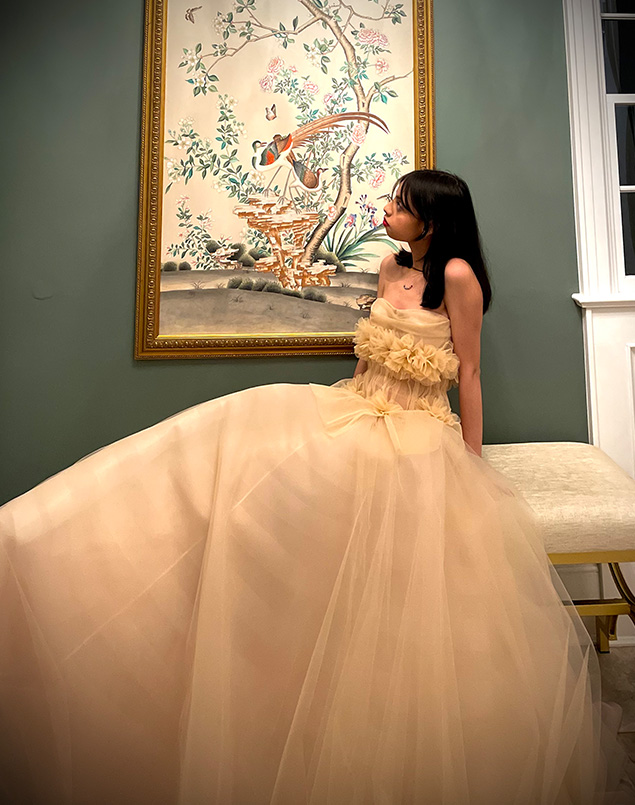 Gown embellished with handmade flowers that vary organically in size