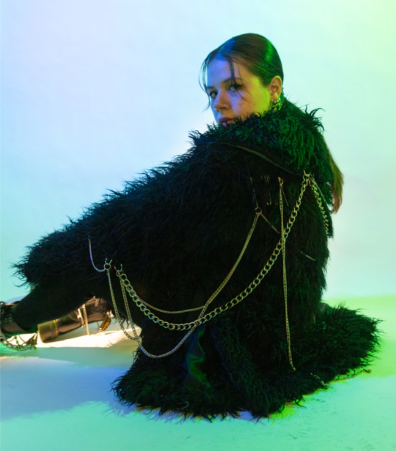 Made from a shaggy faux fur, this oversized coat features a chain detail on its back and sleeve.