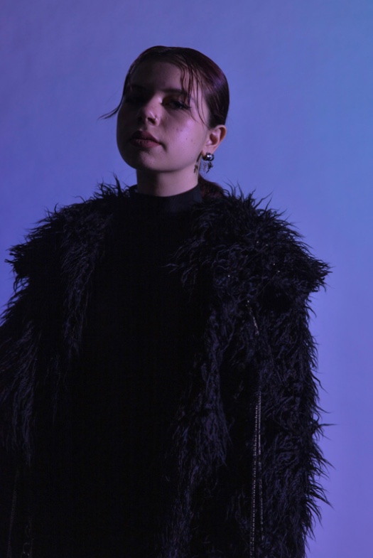 The coat and catsuit are paired together, with the chain detail following to the front of the coat.