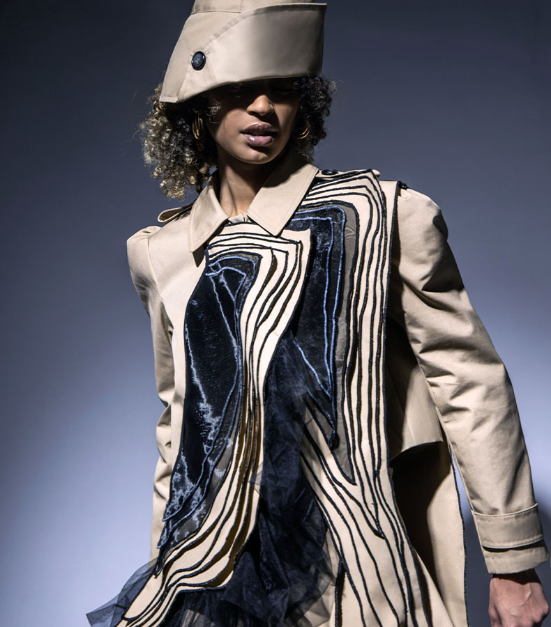 This look has a cropped trench jacket and a full circle skirt with a bucket hat in water-repellent khaki faille fabric.