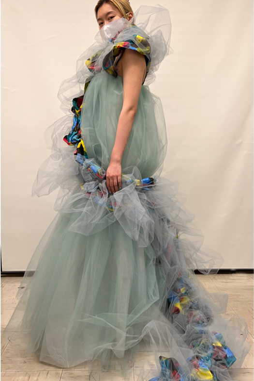 Side view of the whole gown. Showing the train from neck to the ground. The shape of this gown is inspired by the container found in the archaeological site.