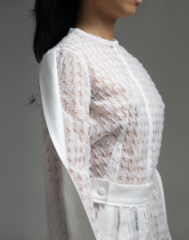 The top worn inside uses both sheer houndstooth fabric and solid white fabric. The neckline is clean-finished with white bias strips. Topstitching detail can be found on the darts.