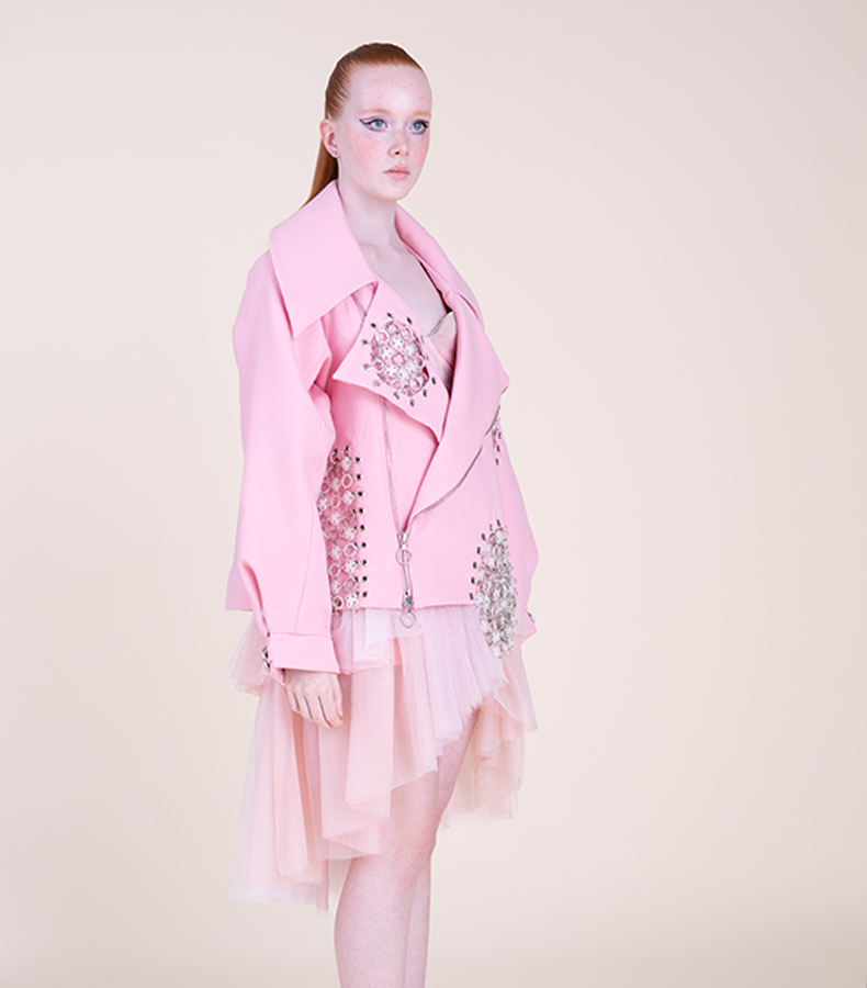 Model is shown wearing the jacket and dress, standing in a 3/4 view of the camera and is shown from the knees up.