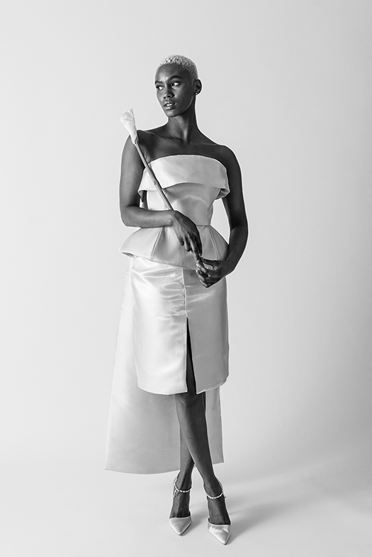 The back of the cape attaches underneath the collar and reveals a center back pleat.