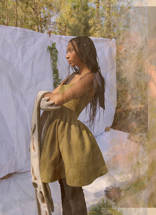 Image 4 shows the model posed 3/4. The look shows mainly the dress. She is standing holding the shawl, and we see more of the crochet gloves.