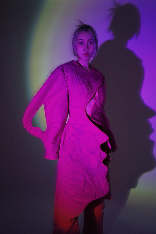 On the right side of the garment is the shape of a face. It is a quilted pattern of a couple sleeping together.