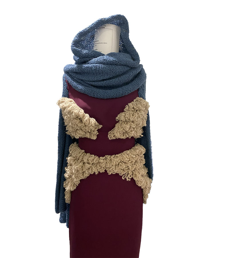 This is an up-close shot of the front of my dress, featuring fuzzy, bouclé alpaca loops and rectangular beading on the hijab.