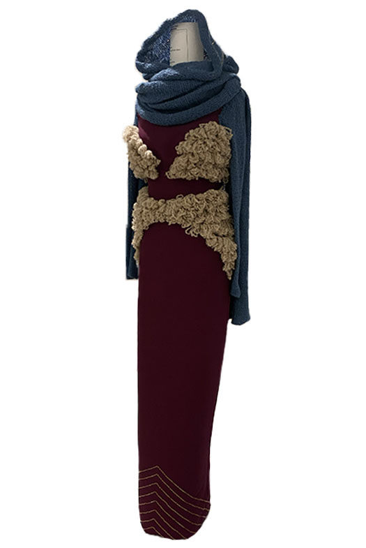 A semi side view of my dress, featuring beading at the bottom that resembles the Rainbow Mountains.