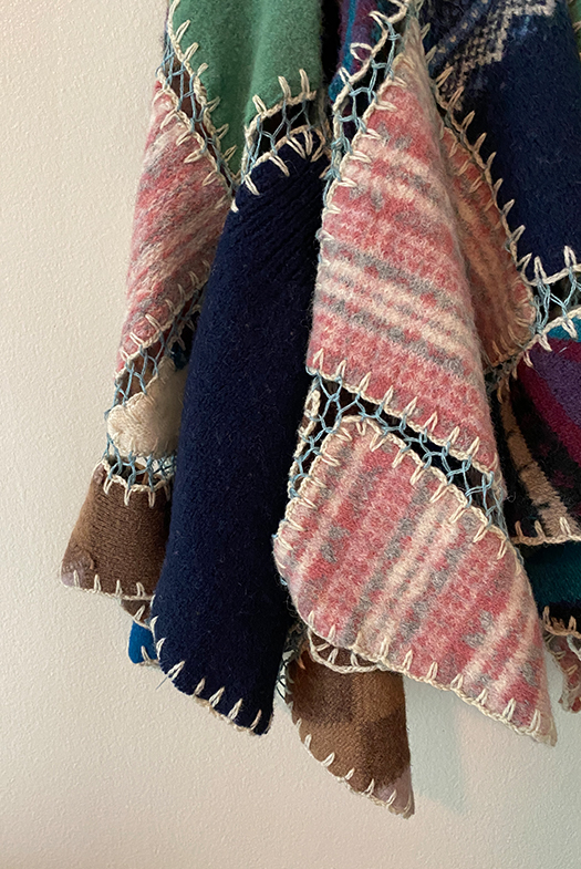 Close-up of a corner of the skirt portion of the dress, showing the drape and the uneven hemline