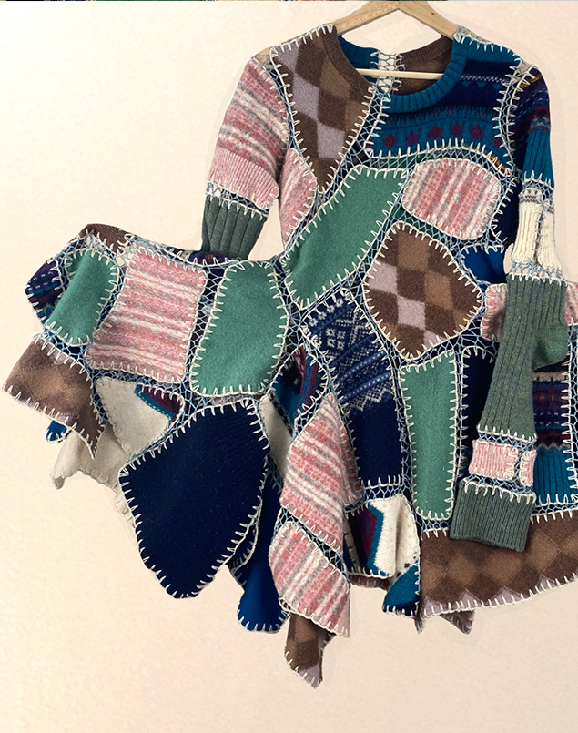 View of the full dress with the skirt pulled straight to show the details of the patchwork