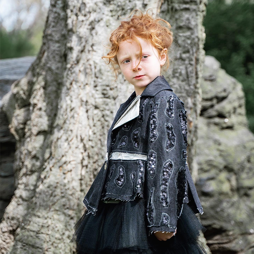 Fabric manipulation was created by cutting and stitching denim and sequins on one side of the jacket. Photo of a little girl, and the background is the nature view.