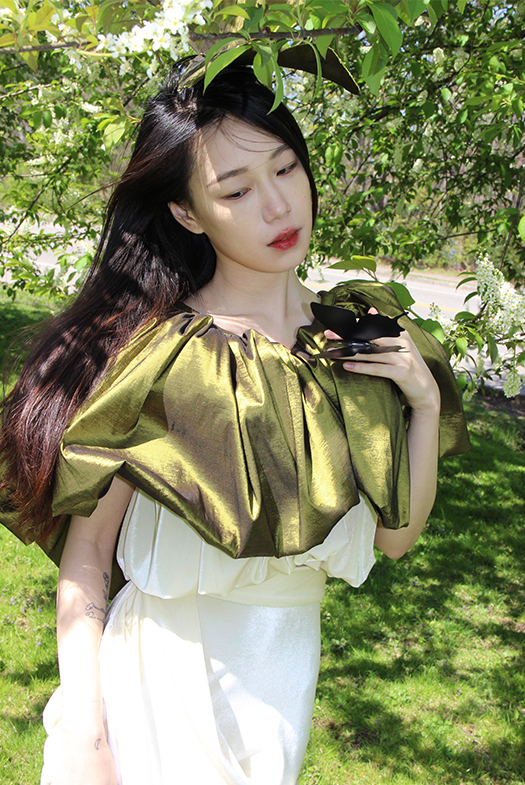 Green taffeta dress with gather details on the bust.