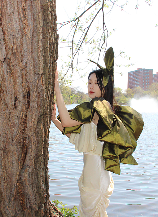 Back view of green taffeta gathered top with butter color velour ruched skirt